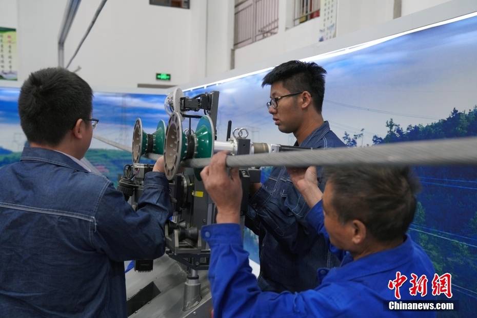 浙江绍兴:供电公司运维人员检查设备 调试除冰机器人